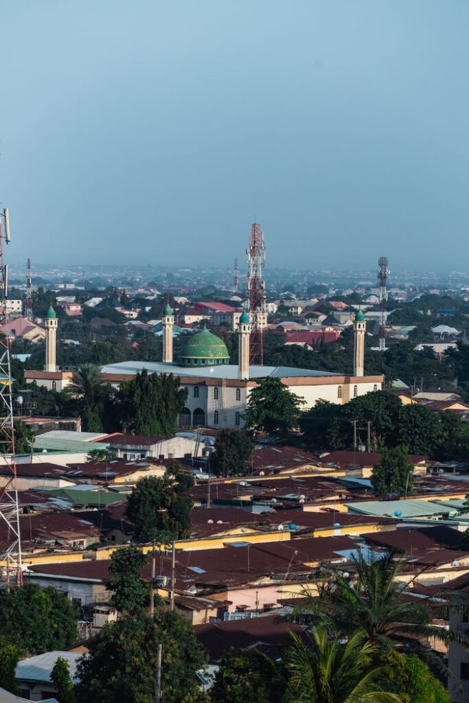 Aerial shot of the National Mosque amidst cityscape in Abuja, Nigeria.